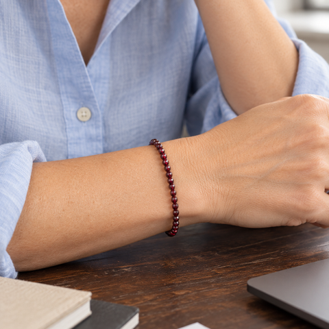 Bracelet facetté en grenat rouge 4 mm porté au poignet à l'échelle annoncée