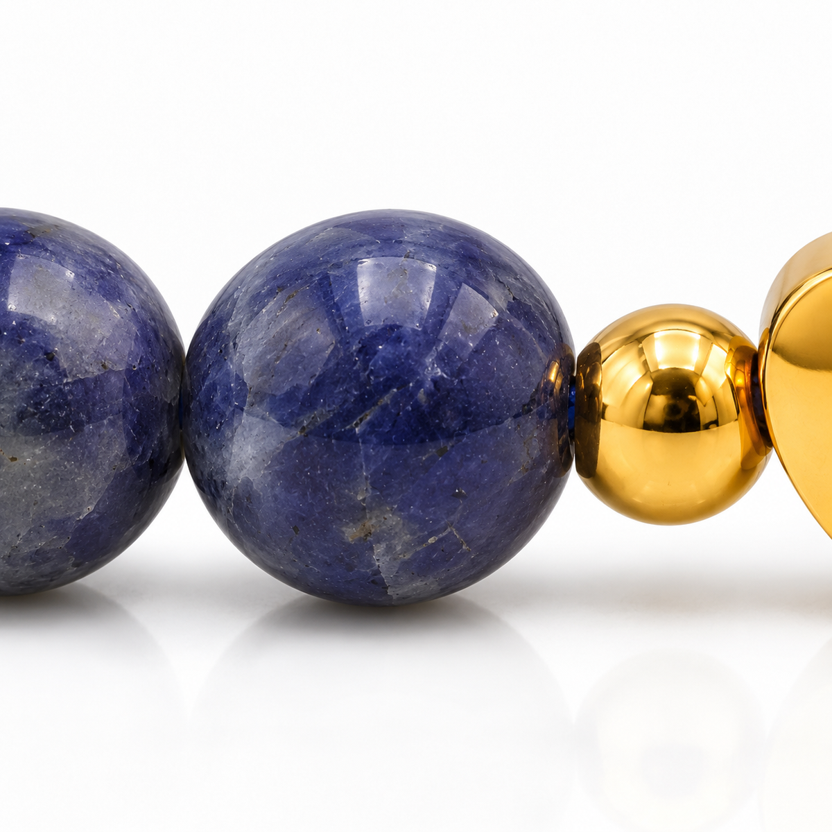Une perle de sodalite et sa connexion à la bille dorée, bracelet continu en gros plan