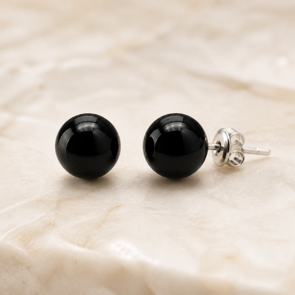 Boucles d'oreilles puces en obsidienne noire - 10 mm, vue complète sur une surface minérale claire
