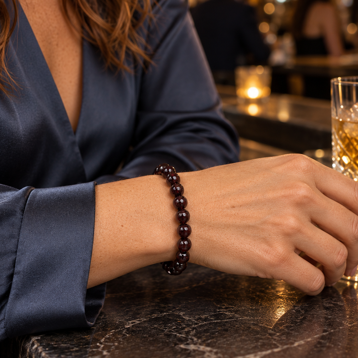 Bracelet en grenat rouge 8 mm porté au poignet à l'échelle annoncée