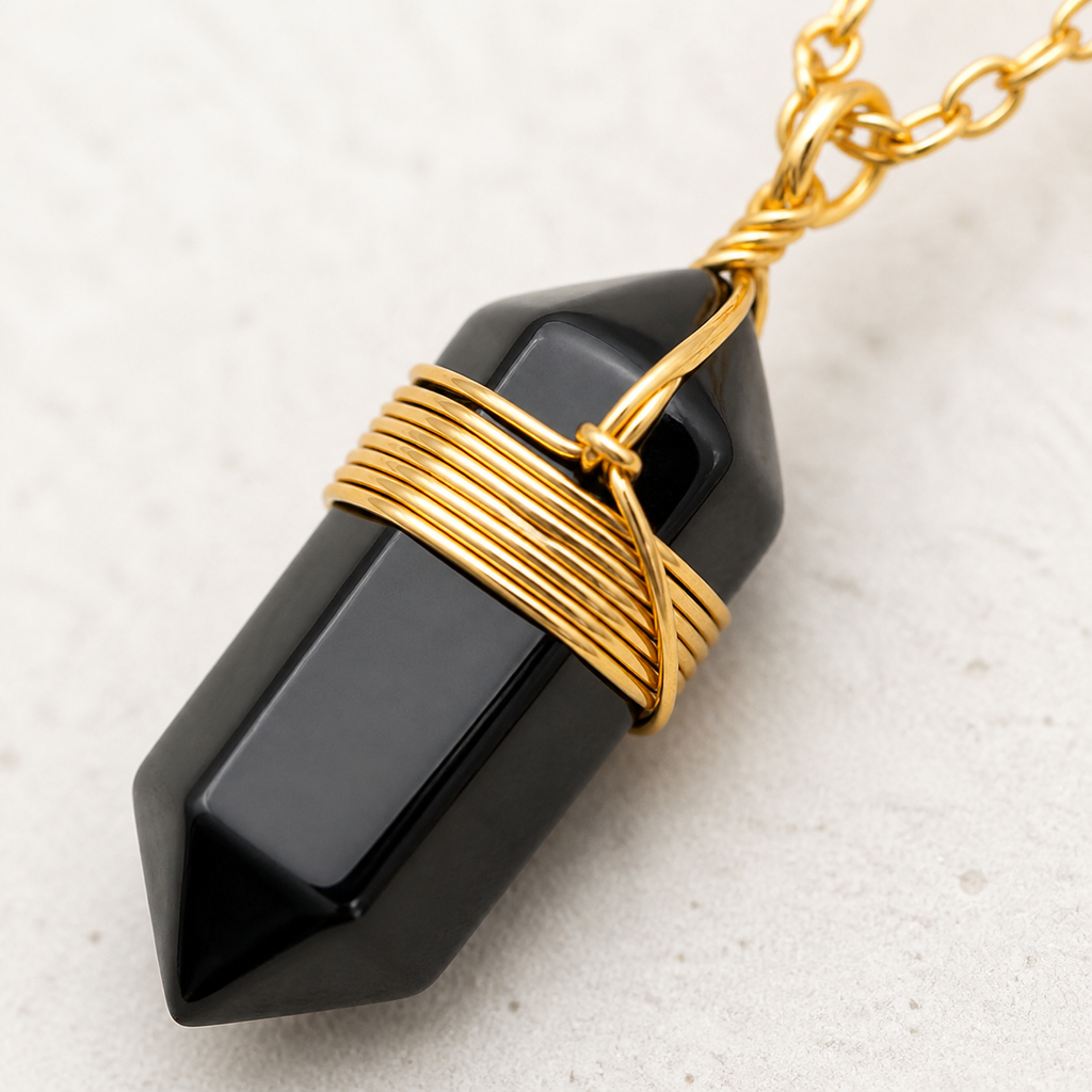 Gros plan de la pointe en obsidienne noire et du fil doré
