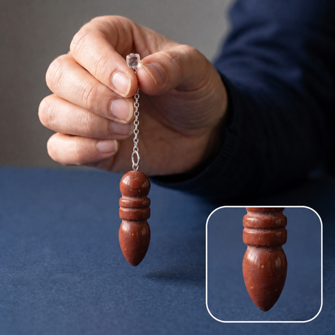 Pendule en jaspe rouge suspendu avec détail agrandi de sa pointe sculptée