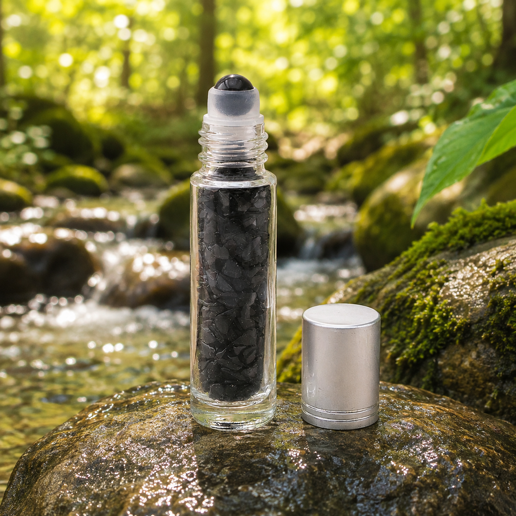 Flacon roll-on en obsidienne noire dans une scène colorée et végétalisée