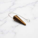 Pendule Œil de Tigre — Photo produit sur marbre